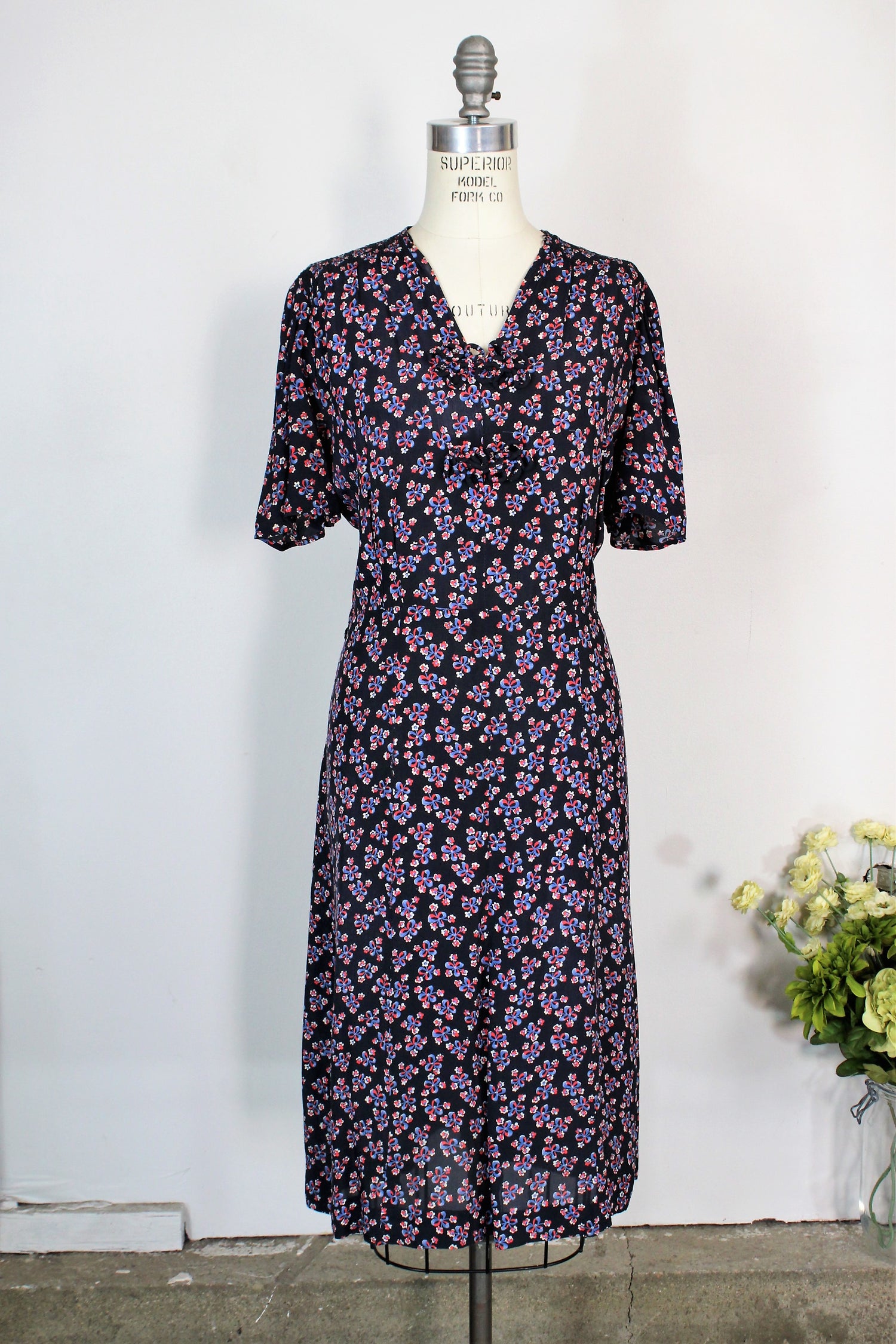 Vintage 1940s Rayon Day Dress With A Floral And Bow Print In Red White And Blue