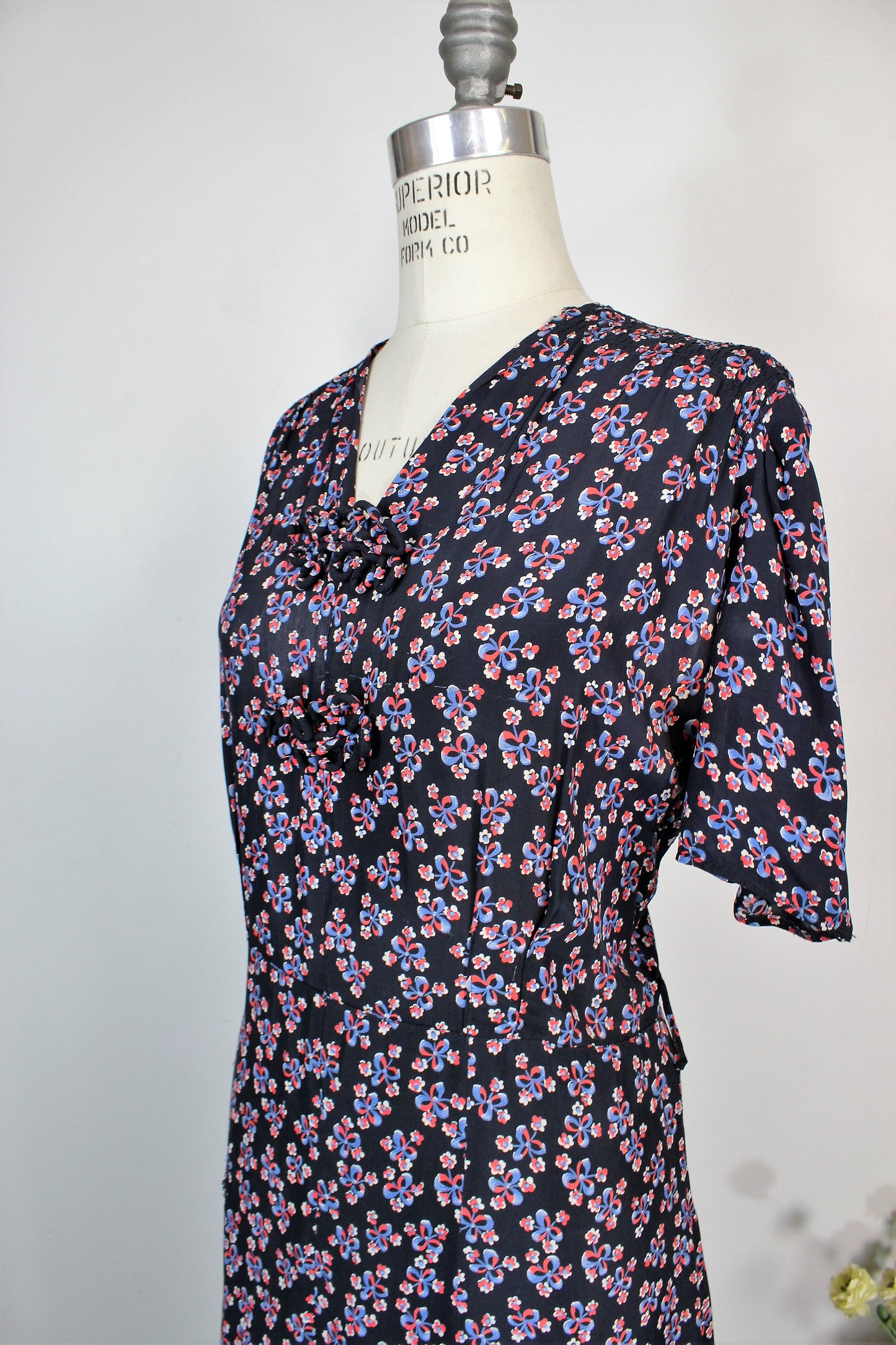 Vintage 1940s Rayon Day Dress With A Floral And Bow Print In Red White And Blue